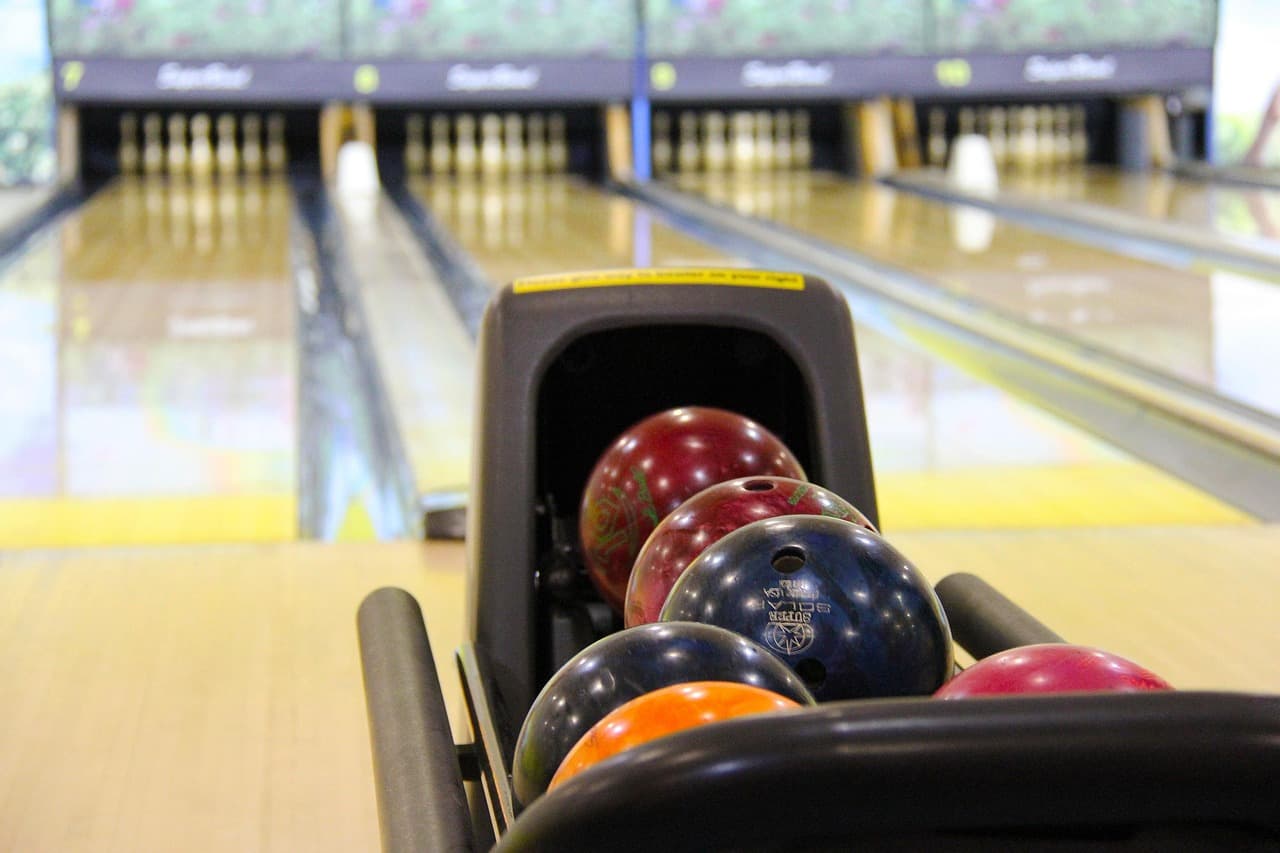 Bowling ball striking pins on a modern bowling lane